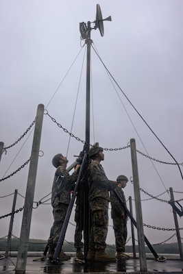U.S. Marines with A Company and B Company, 7th Communication Battalion, III Marine Expeditionary Force Information Group, set up a Long-Range Radio System during Exercise Triad Thunder as part of Kaiju Rain on Camp Hansen, Okinawa, Japan, May 5, 2025.