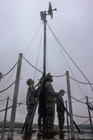 U.S. Marines with A Company and B Company, 7th Communication Battalion, III Marine Expeditionary Force Information Group, set up a Long-Range Radio System during Exercise Triad Thunder as part of Kaiju Rain on Camp Hansen, Okinawa, Japan, May 5, 2025.