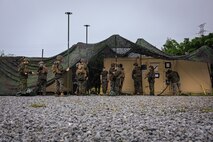 U.S. Marines with Service Company, 7th Communication Battalion, III Marine Expeditionary Force Information Group, lift Cammie netting during Exercise Triad Thunder as part of Kaiju Rain on Camp Hansen, Okinawa, Japan, May 5, 202