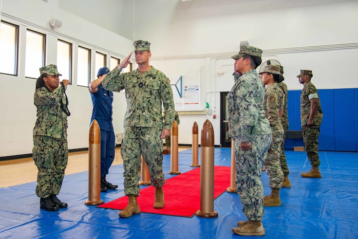 Joint sideboys render honors to U.S. Navy Rear Adm. Josh Lasky, incoming commander, Joint Task Force - Micronesia, during a change of command ceremony at Marine Corps Base Camp Blaz Fitness Center, May 15.