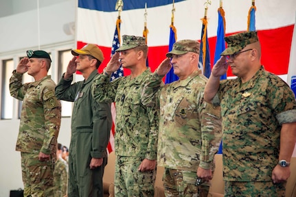 Senior leadership salutes the colors as the national anthem plays during Joint Task Force - Micronesia’s change of command ceremony at Marine Corps Base Camp Blaz Fitness Center, May 15.