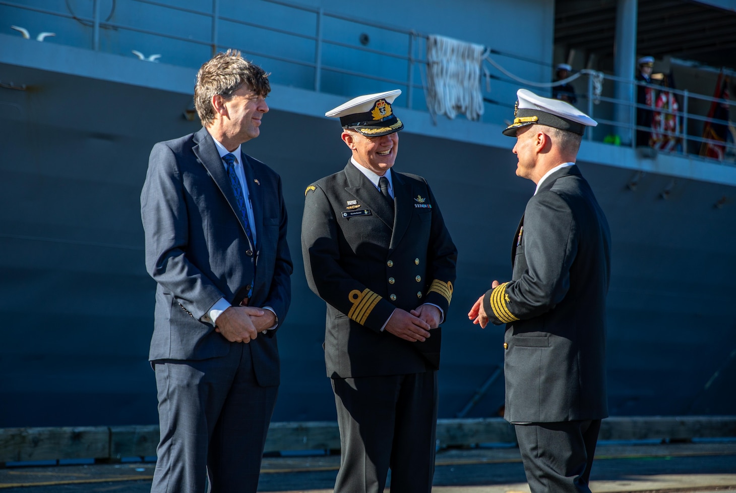 250516-N-FA353-1026 WELLINGTON, New Zealand (May 16, 2025) U.S. Navy Capt. Nicholas DeLeo, right, commanding officer of the U.S. 7th Fleet flagship USS Blue Ridge (LCC 19), greets Mr. David Gehrenbeck, left, Chargé d’affaires, U.S. Embassy New Zealand, and Royal New Zealand Navy Capt. Quentin Randall, assistant chief of navy-strategy and engagement, during a welcome ceremony for Blue Ridge's arrival in Wellington, New Zealand during a scheduled port visit, May 16, 2025. U.S. 7th Fleet is the U.S. Navy's largest forward-deployed numbered fleet, and routinely interacts and operates with allies and partners in preserving a free and open Indo-Pacific region. (U.S. Navy Photo by Mass Communication Specialist 2nd Class Belen Saldana)