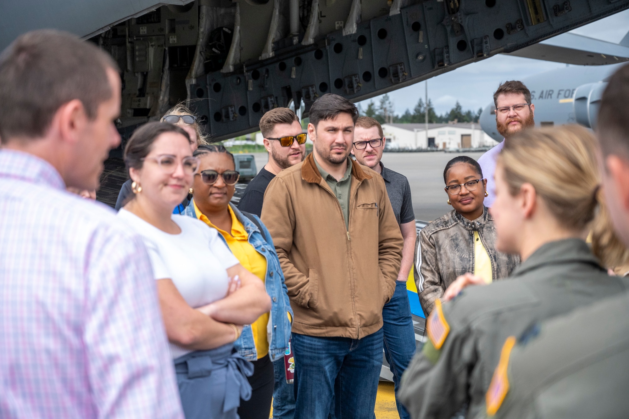 U.S. Air Force Airmen with the 62d Airlift Wing brief Sandia National Laboratories Weapon Intern Program participants about C-17 Globemaster III capabilities at Joint Base Lewis-McChord, Washington, May 7, 2025.