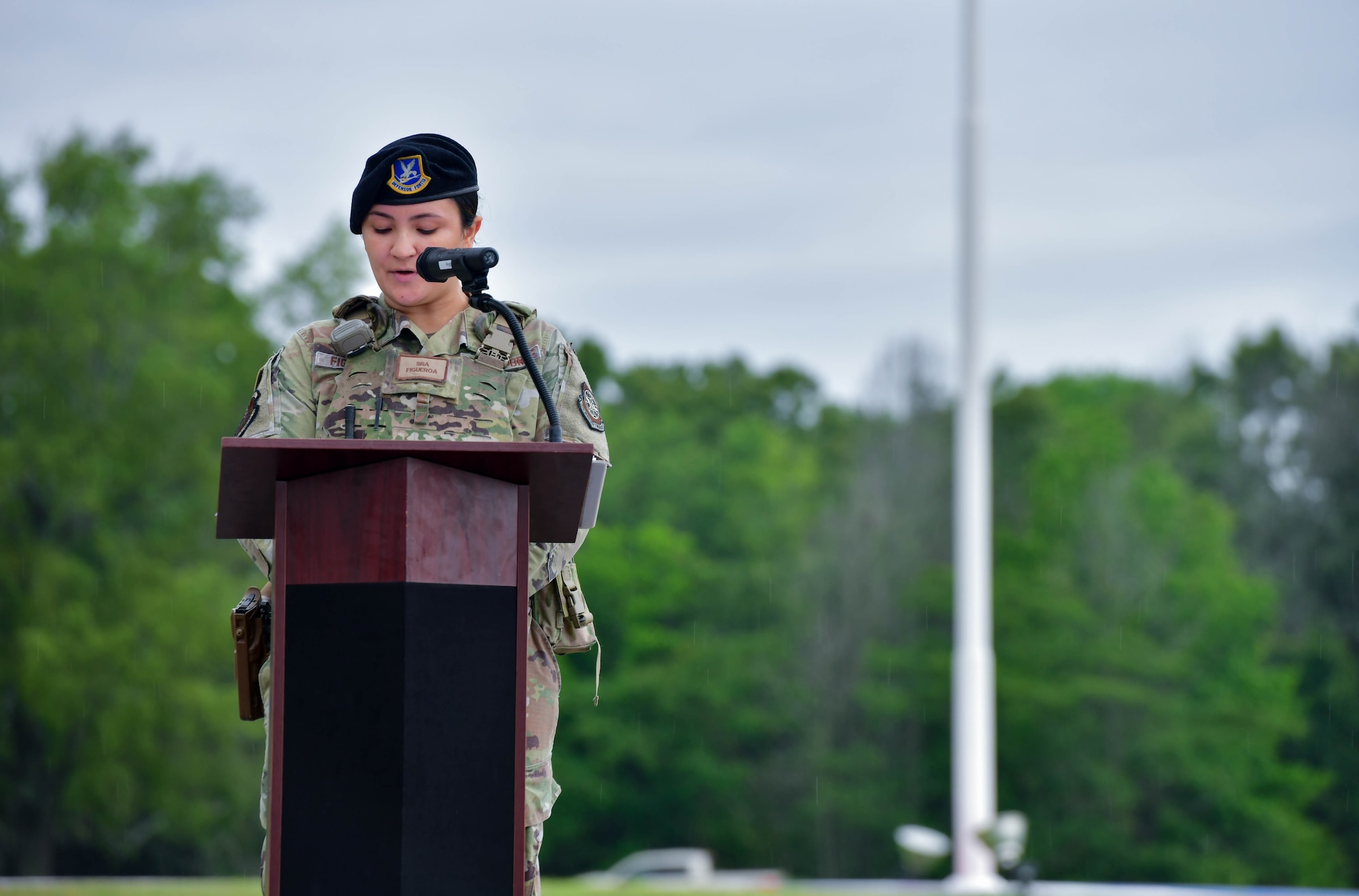Airman speaks at podium.
