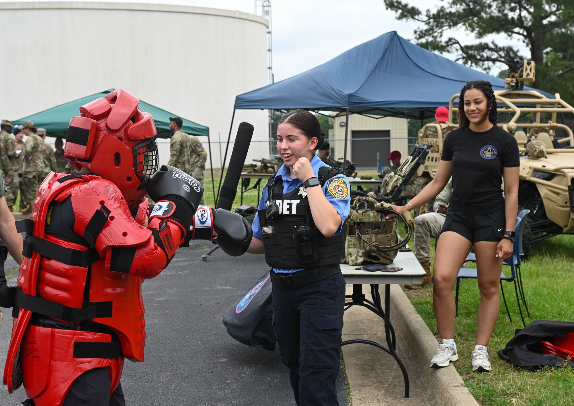 Police cadet and airman participate in combat demonstration.