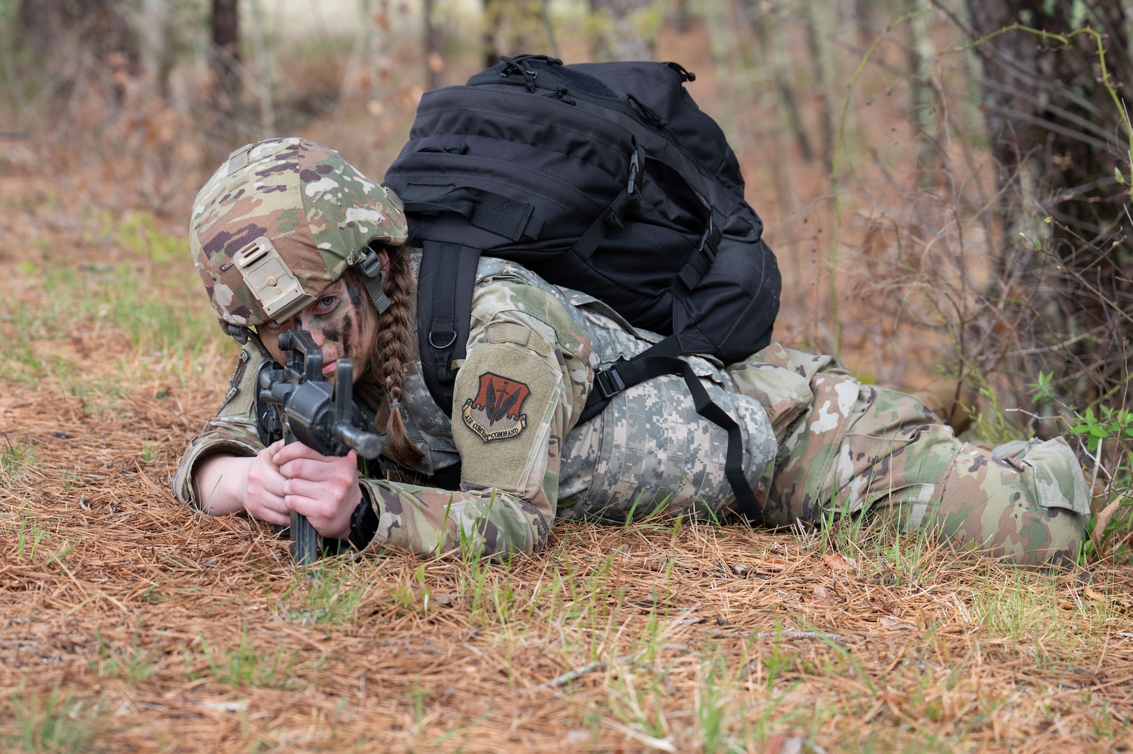 Airman assumes prone position during a ruck march.