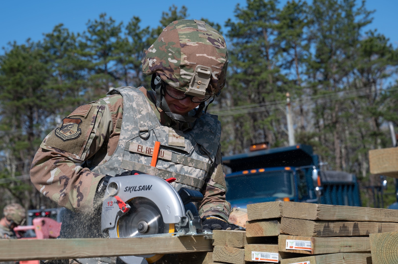 Airman cuts a piece of wood.