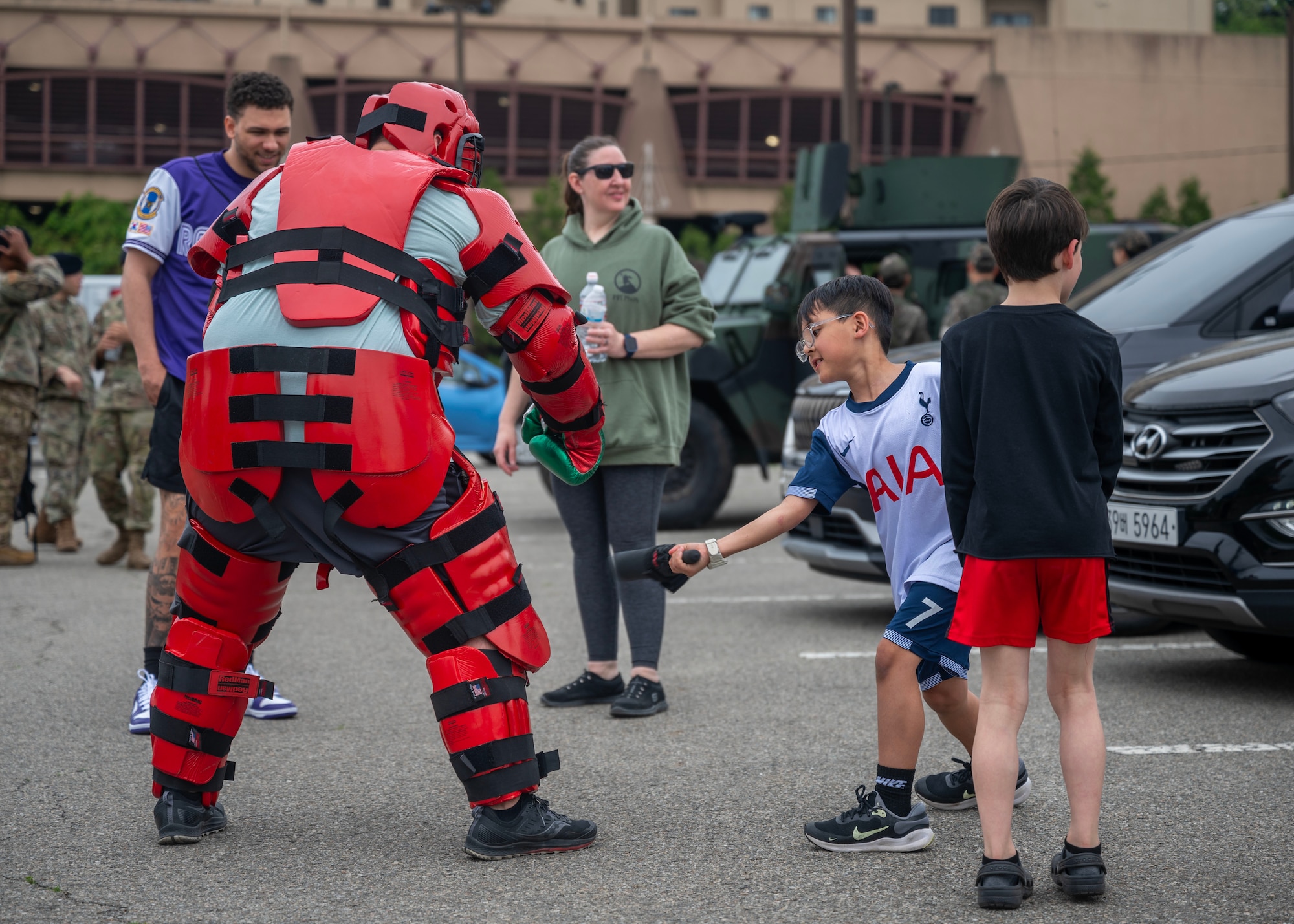 U.S. Air Force Tech. Sgt. Caesar Reyna, 51st Security Forces Squadron flight sergeant, is struck during a baton training drill as part of a  Law Enforcement Display in recognition of 2025 National Police Week at Osan Air Base, Republic of Korea, May 15, 2025. The use of the bodysuit and baton training equips defenders with non-lethal force options, enabling them to control and de-escalate high-threat situations safely and effectively.  (U.S. Air Force photo by Senior Airman Sarah Williams)