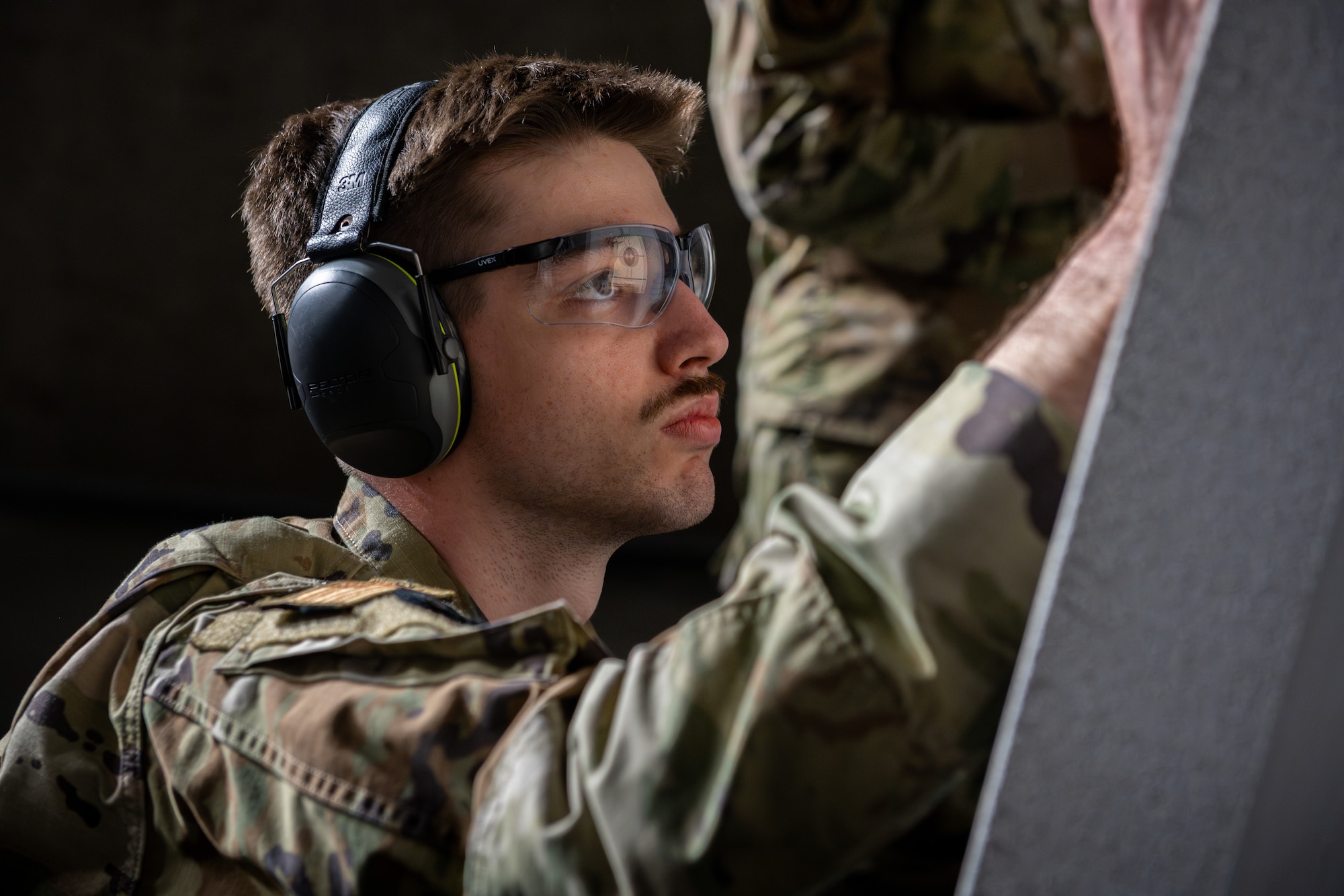 An Airman checks his shot groupings after a round of fire.