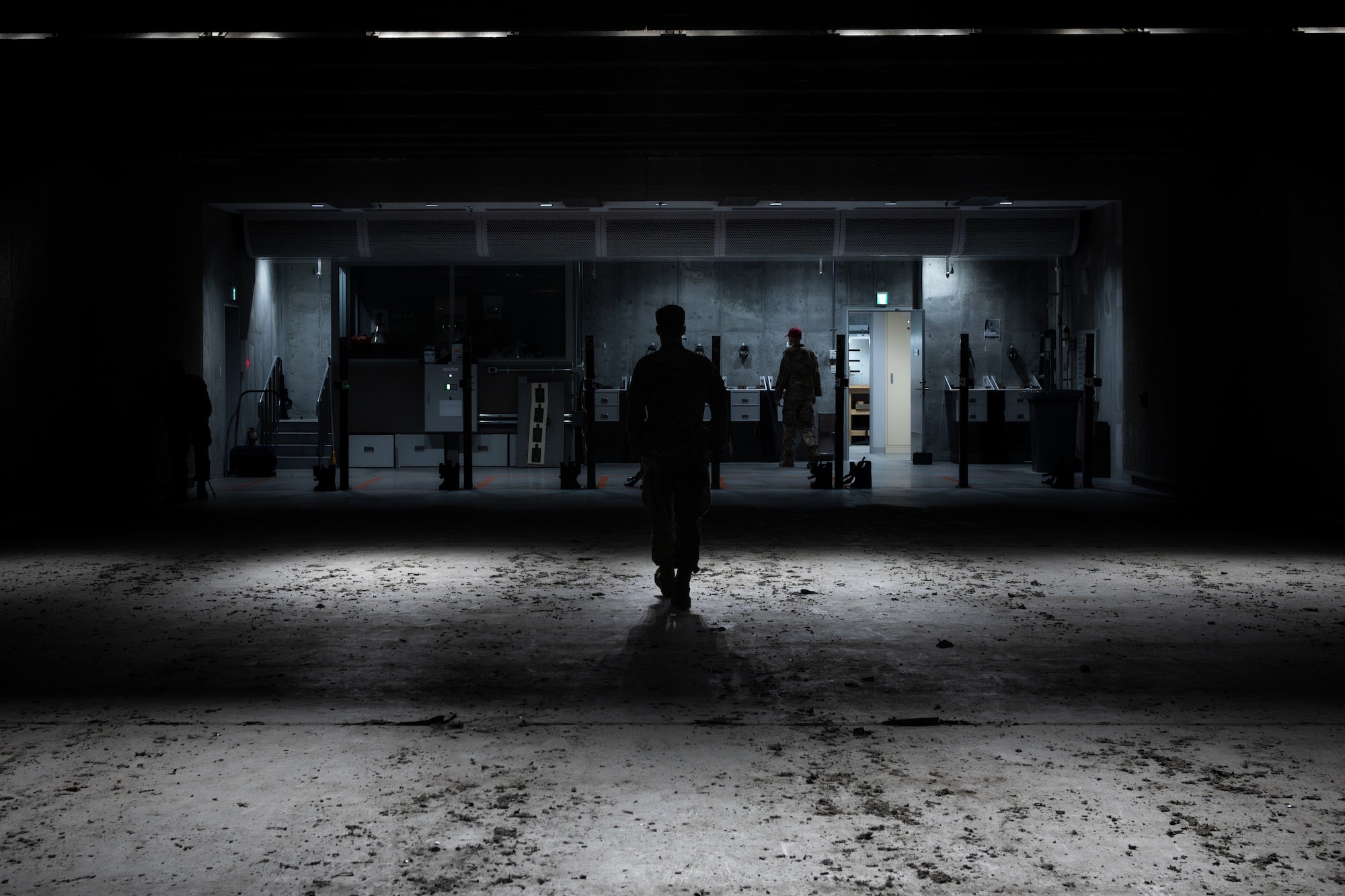 An Airman walks back down the range, silhouetted.