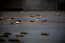 Spent shell casings are scattered on the ground.