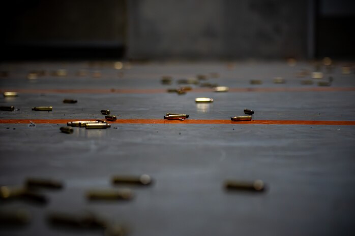 Spent shell casings are scattered on the ground.