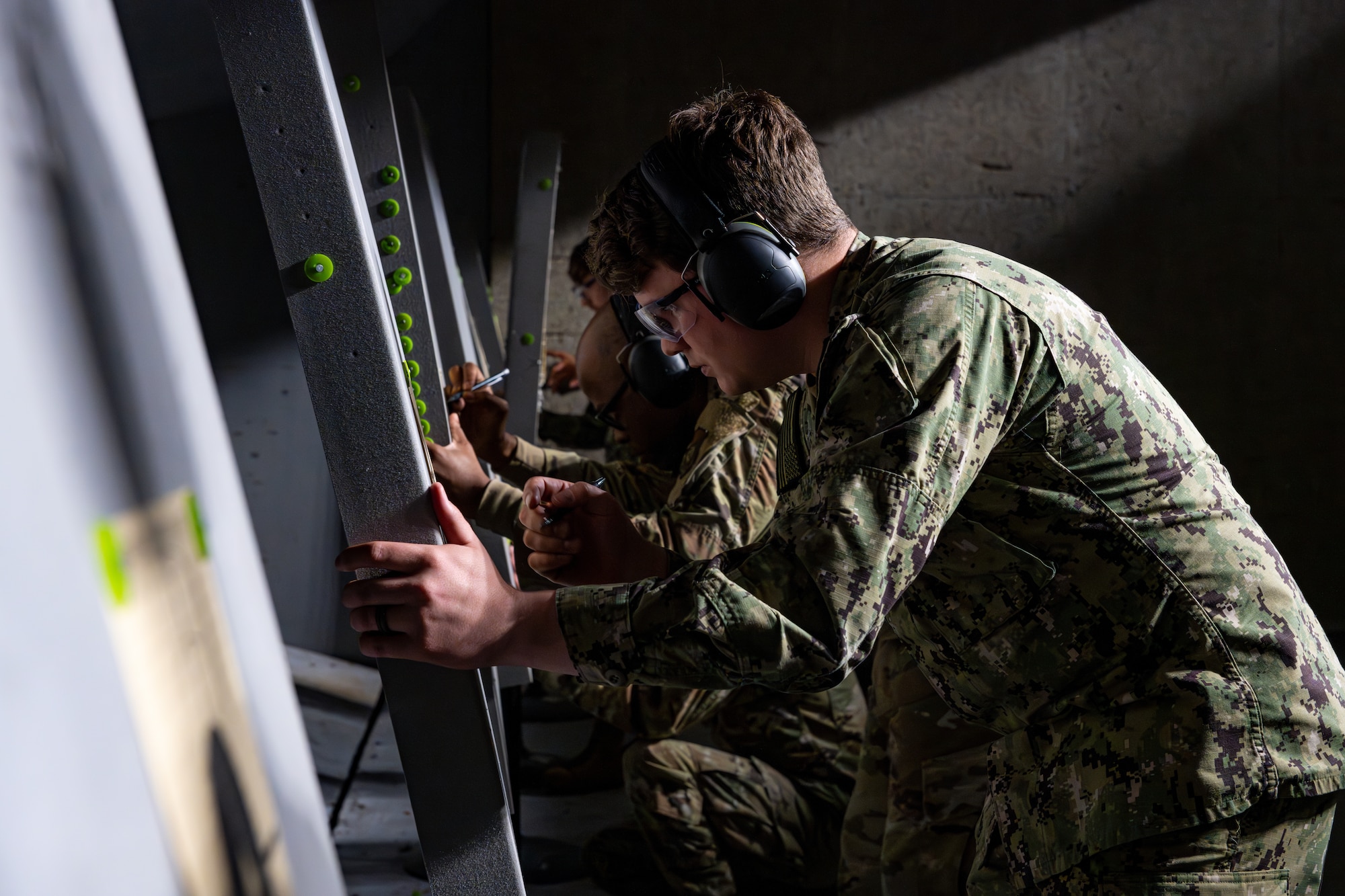 U.S. military members check their groupings after a round of fire.