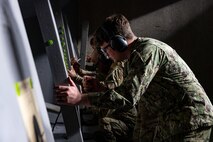 U.S. military members check their groupings after a round of fire.