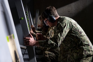 U.S. military members check their groupings after a round of fire.