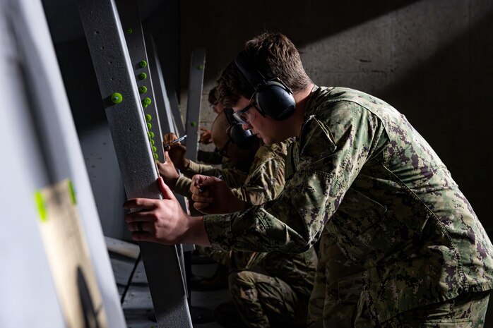 U.S. military members check their groupings after a round of fire.