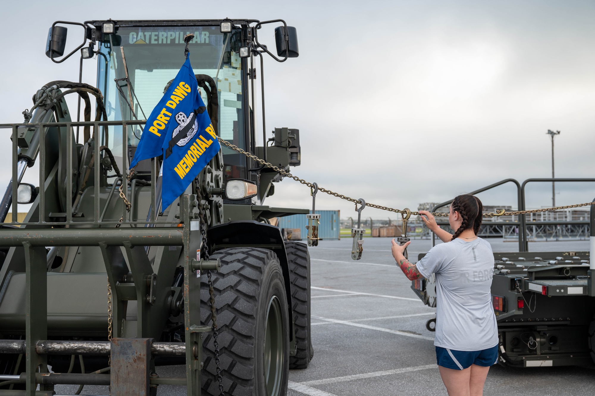 Service member hangs device on chain.
