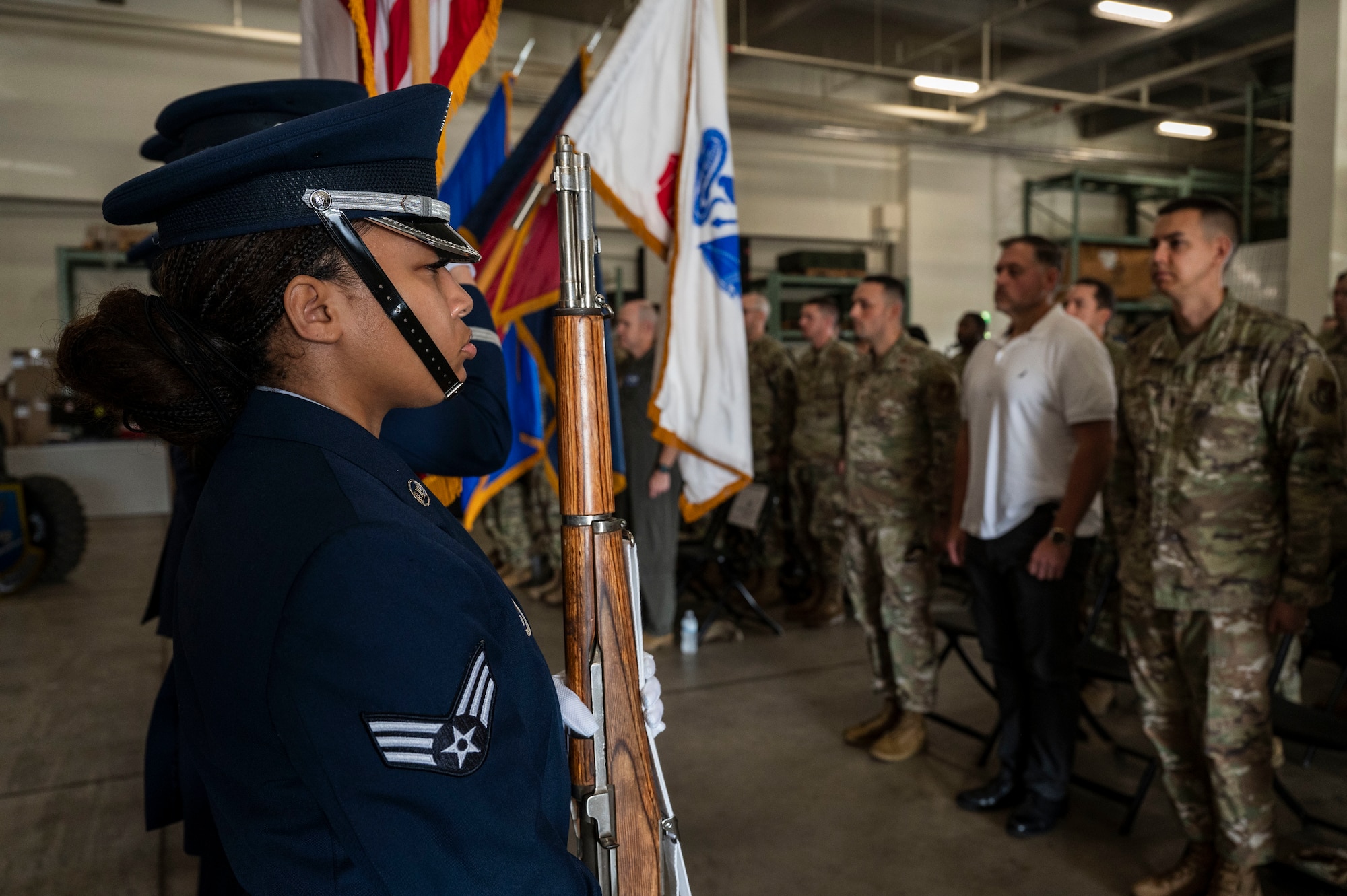 U.S. Air Force Senior Airman Nkayla Williams, 18th Wing honor guardsman, presents the colors during the national anthem at the police week closing ceremony