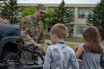 U.S. Air Force Senior Airman Ty Thomas, 35th Security Forces Squadron Defender, shows a variety of firearms employed by Security Forces to attendees during a Police Week demonstration.