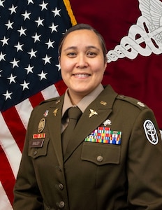 LTC Joanna A. Bailey with the U.S. flag and MEDCOM flag behind her.