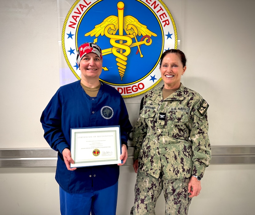 250512-N-WJ173-1001 SAN DIEGO (May 2025) – Lt. Melissa Campbell (left), Division Officer of the Main Operating Room at Naval Medical Center San Diego (NMCSD), is presented the Junior Officer of the Quarter award for Fiscal Year 2025, Quarter 1 by Capt. Elizabeth Adriano (right), NMCSD Director, 12 May, 2025.  Campbell was recognized for her outstanding leadership, oversight of more than 2,500 surgical cases, introduction of ENT robotics, and the launch of surgical telementoring—all of which contribute directly to enhanced warfighter readiness and surgical capability.  The mission of NMCSD is to provide a superior experience for our patients, staff, and warfighters. NMCSD employs more than 5,000 active-duty military personnel, civilians, and contractors in Southern California to deliver exceptional care afloat and ashore.