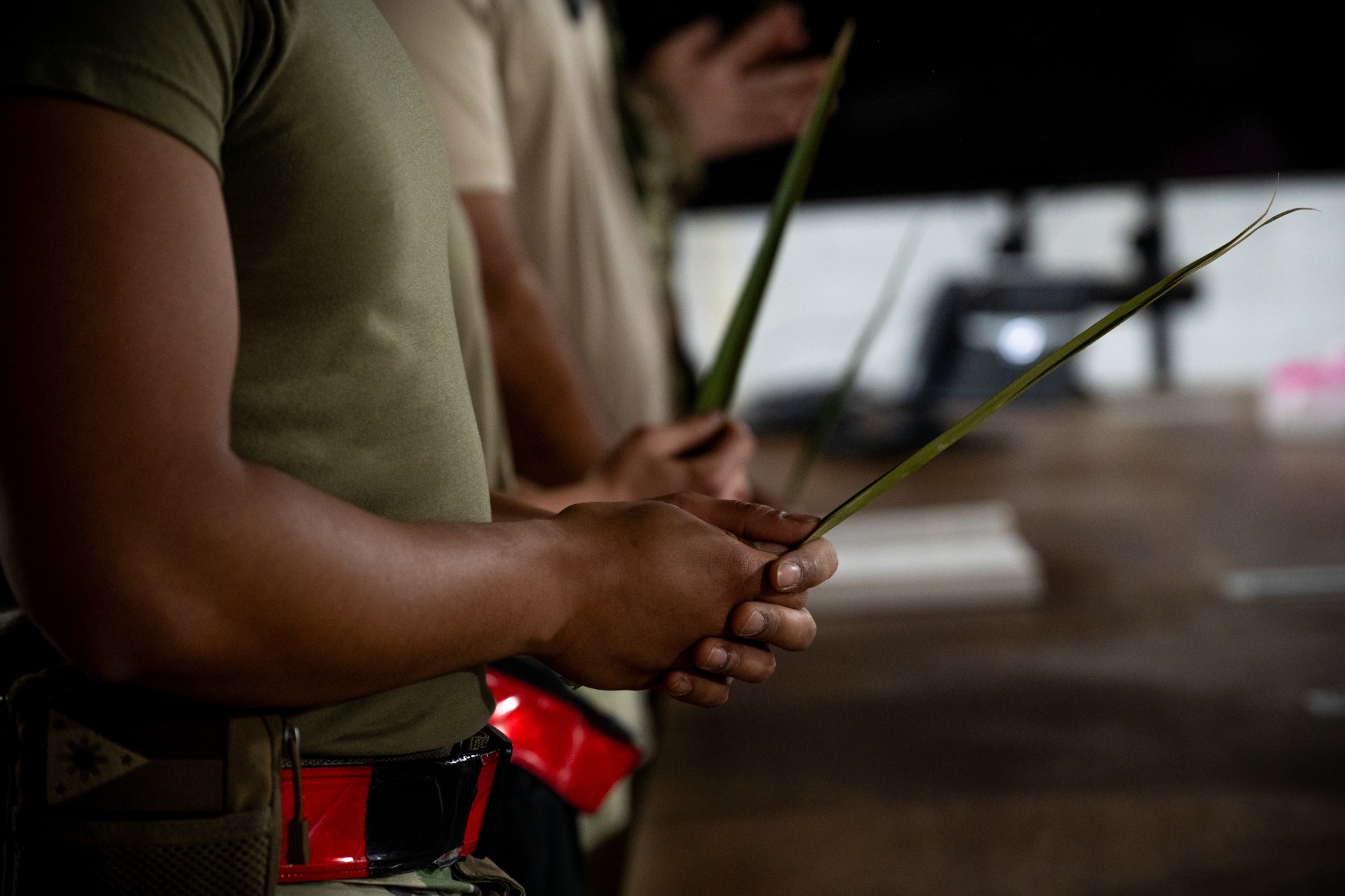 Airman holds a palm leaf