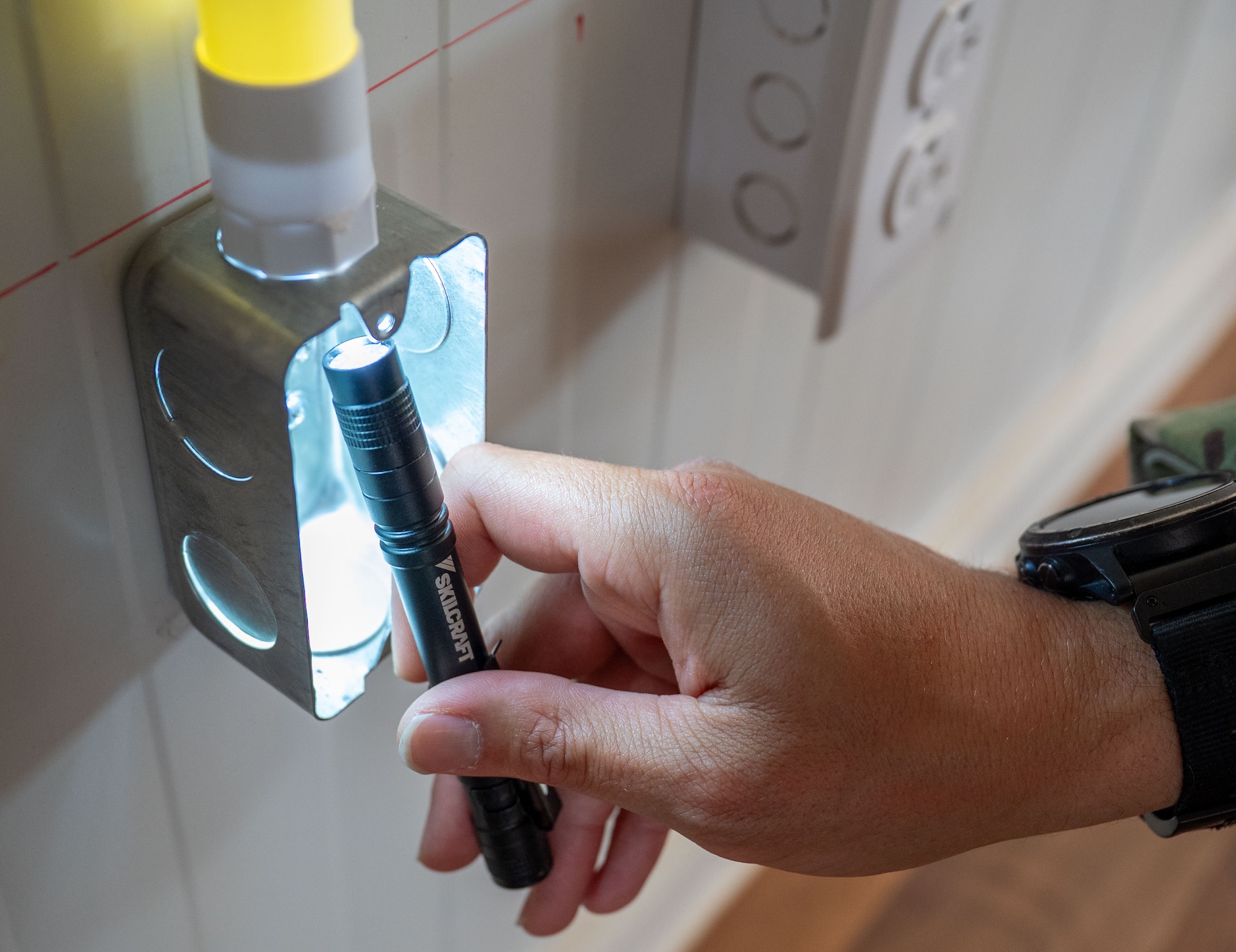 A flashlight is shown inside a data port.