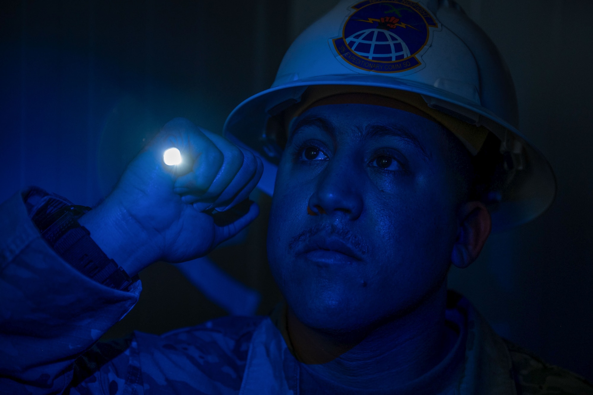 A man shines a flashlight.