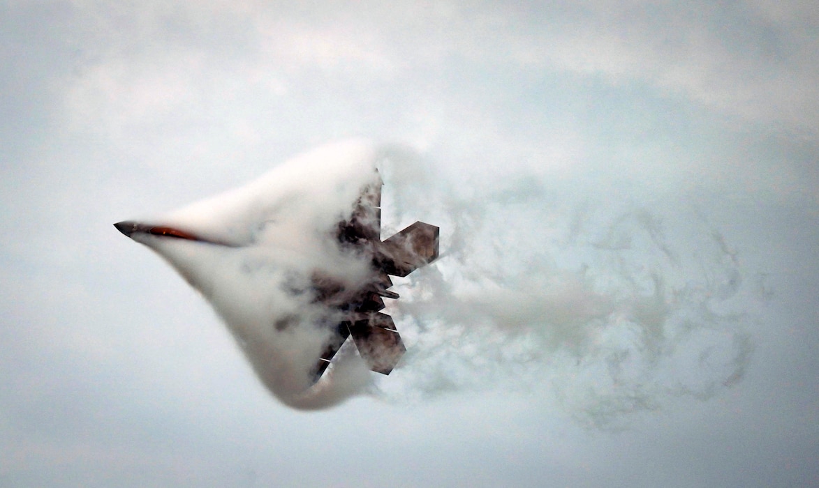 F-22 flying through smoke