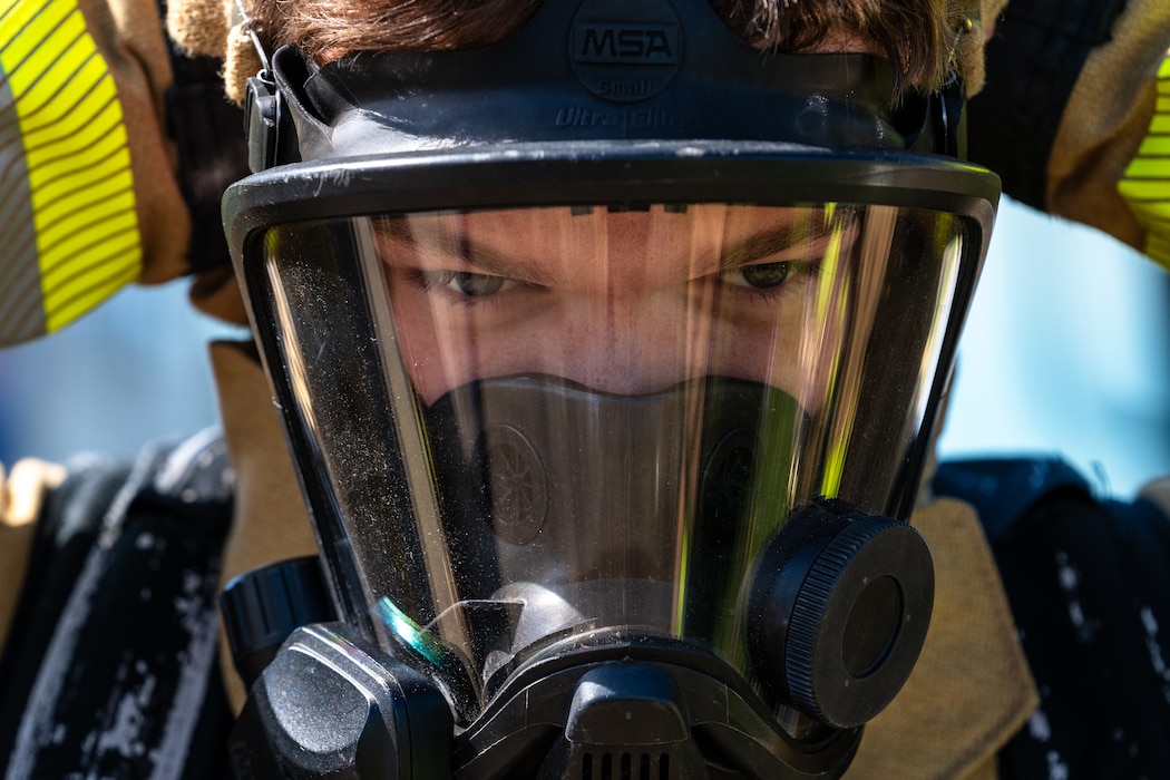 Airman adjusting mask