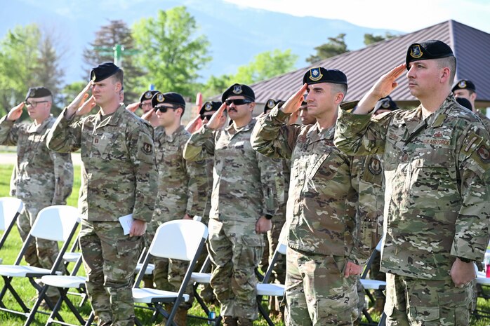 Several Airmen saluting