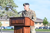 A speaker on a stage behind a podium