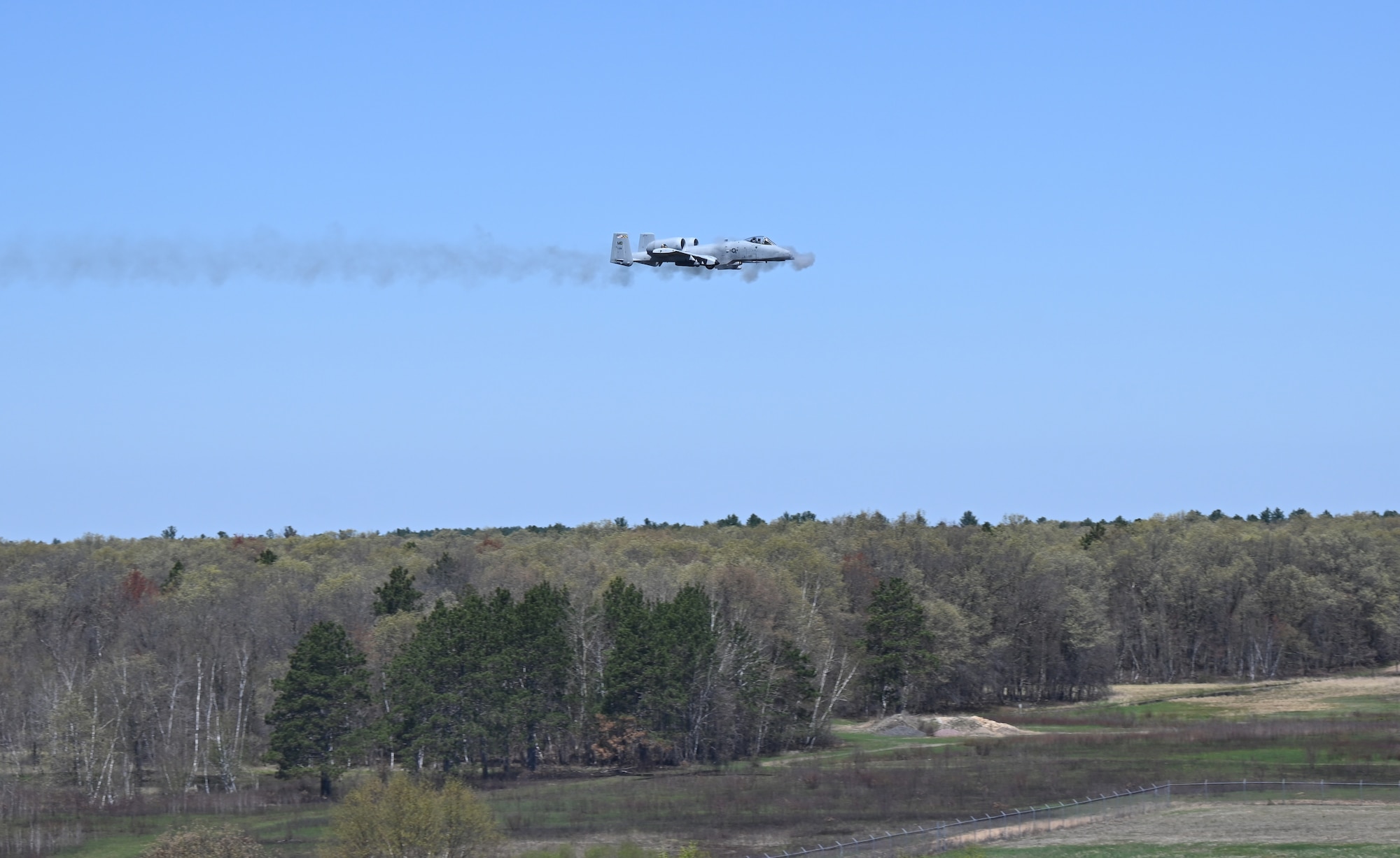 An A-10C Thunderbolt II aircraft assigned to the 104th Fighter Squadron, Maryland Air National Guard, shoots 300mm from the GAU-8/A Avenger Gatling gun during Combat Search and Rescue training at the Hardwood Range, Wisconsin, May 9, 2025. The 175th Wing conducted Combat Search and Rescue training at the Volk Field Combat Readiness Training Center from May 7-15. (U.S. Air National Guard photo by Senior Master Sgt. Chris Schepers)