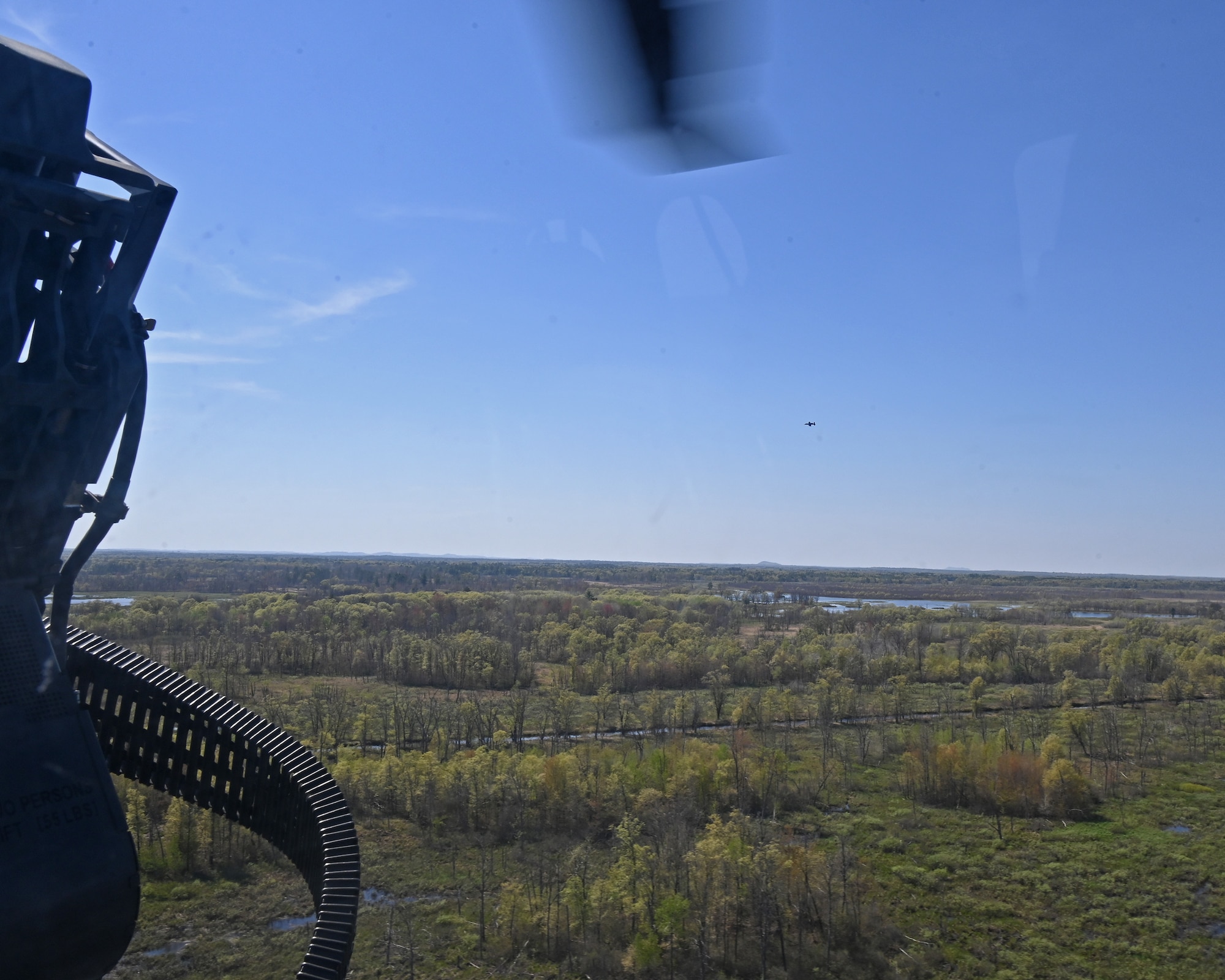 An A-10C Thunderbolt II aircraft assigned to the 104th Fighter Squadron, Maryland Air National Guard, flies with a HH-60W Jolly Green II helicopter assigned to the New York Air National Guard's 160th Rescue Squadron during Combat Search and Rescue training at the Hardwood Range, Wisconsin, May 12, 2025. Combat Search and Rescue, or CSAR, is one of the three primary functions of the A-10C Thunderbolt II, which also conducts close air support missions and airborne forward air control. (U.S. Air National Guard photo by Senior Master Sgt. Chris Schepers)