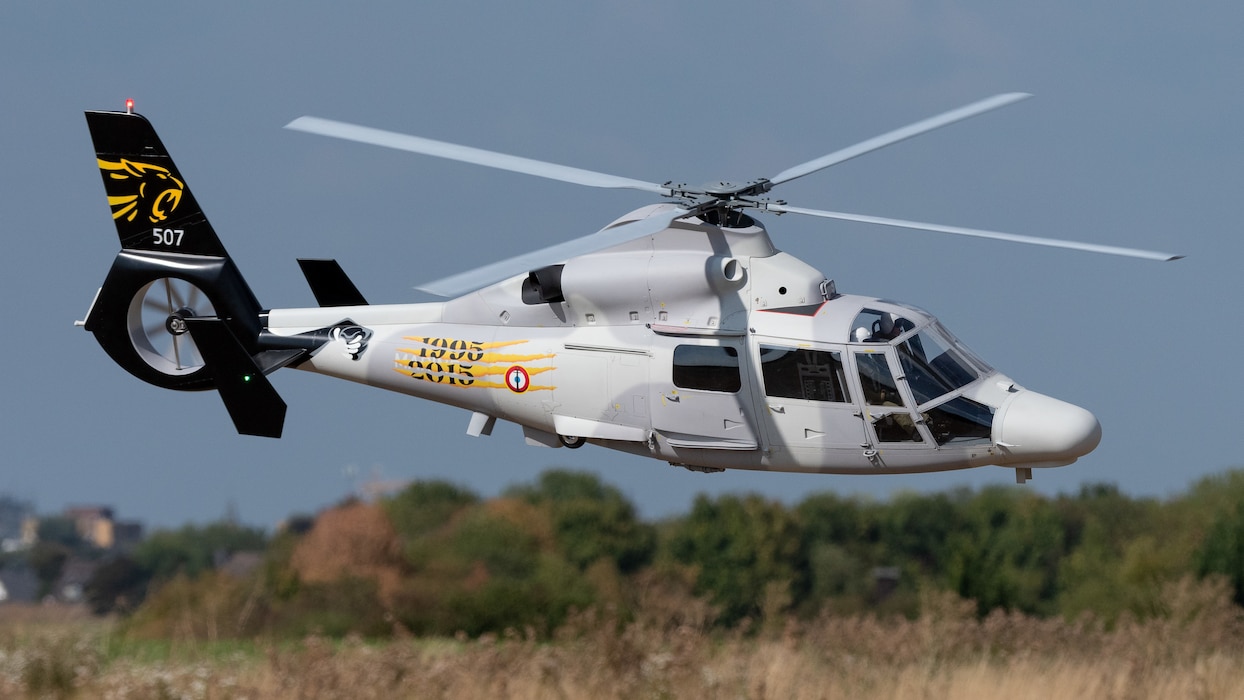 a white, scale, radio-controlled helicopter about to land