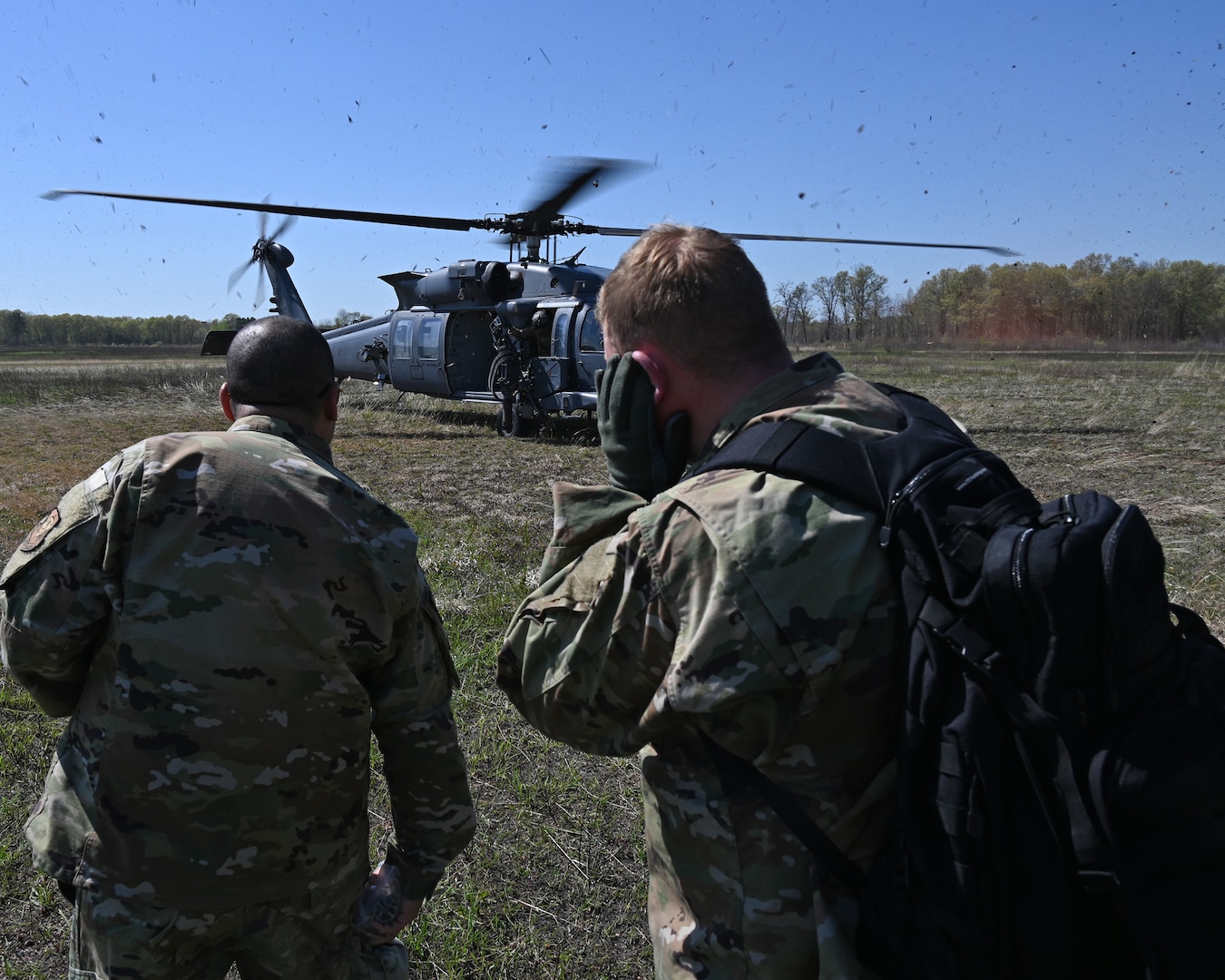 Airmen assigned to the 175th Wing, Maryland Air National Guard, prepare to board a HH-60W Jolly Green II helicopter during combat search and rescue training at the Hardwood Range, Wisconsin, May 12, 2025. The HH-60W Jolly Green II helicopter was part of the Combat Search and Rescue task force element during the week-long training. (U.S. Air National Guard photo by Senior Master Sgt. Chris Schepers)