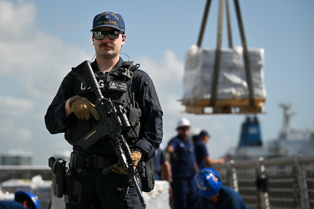 Petty Officer 2nd Class David Hopkins, a gunner’s mate aboard U.S. Coast Guard Cutter Calhoun (WMSL 759), stands watch over illegal narcotics in Port Everglades, May 16, 2025. Calhoun’s crew offloaded more than 19,055 pounds of cocaine and marijuana valued at approximately $140.9 million in Port Everglades, May 16, 2025. (Coast Guard photo by Petty Officer 3rd Class Jessica Walker)