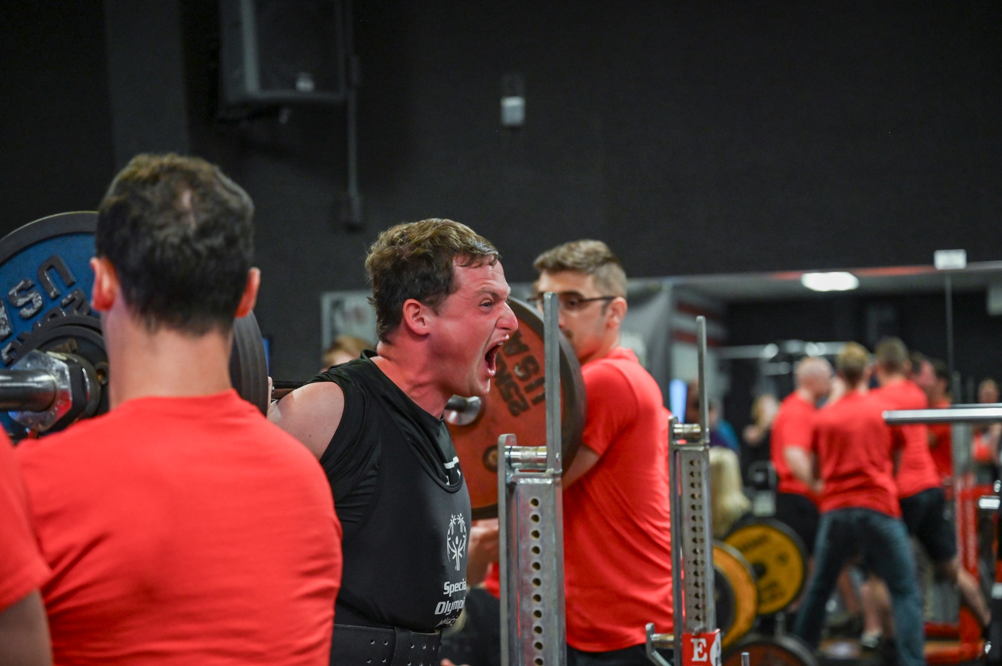 An athlete attempting a squat in competition