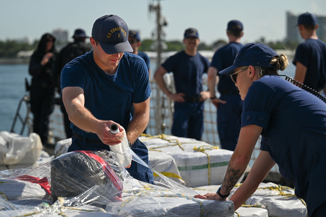 Crew members aboard U.S. Coast Guard Cutter Calhoun (WMSL 759) wraps a pallet of illegal narcotics in Port Everglades, May 16, 2025. Calhoun’s crew offloaded more than 19,055 pounds of cocaine and marijuana valued at approximately $140.9 million in Port Everglades, May 16, 2025. (Coast Guard photo by Petty Officer 3rd Class Jessica Walker)