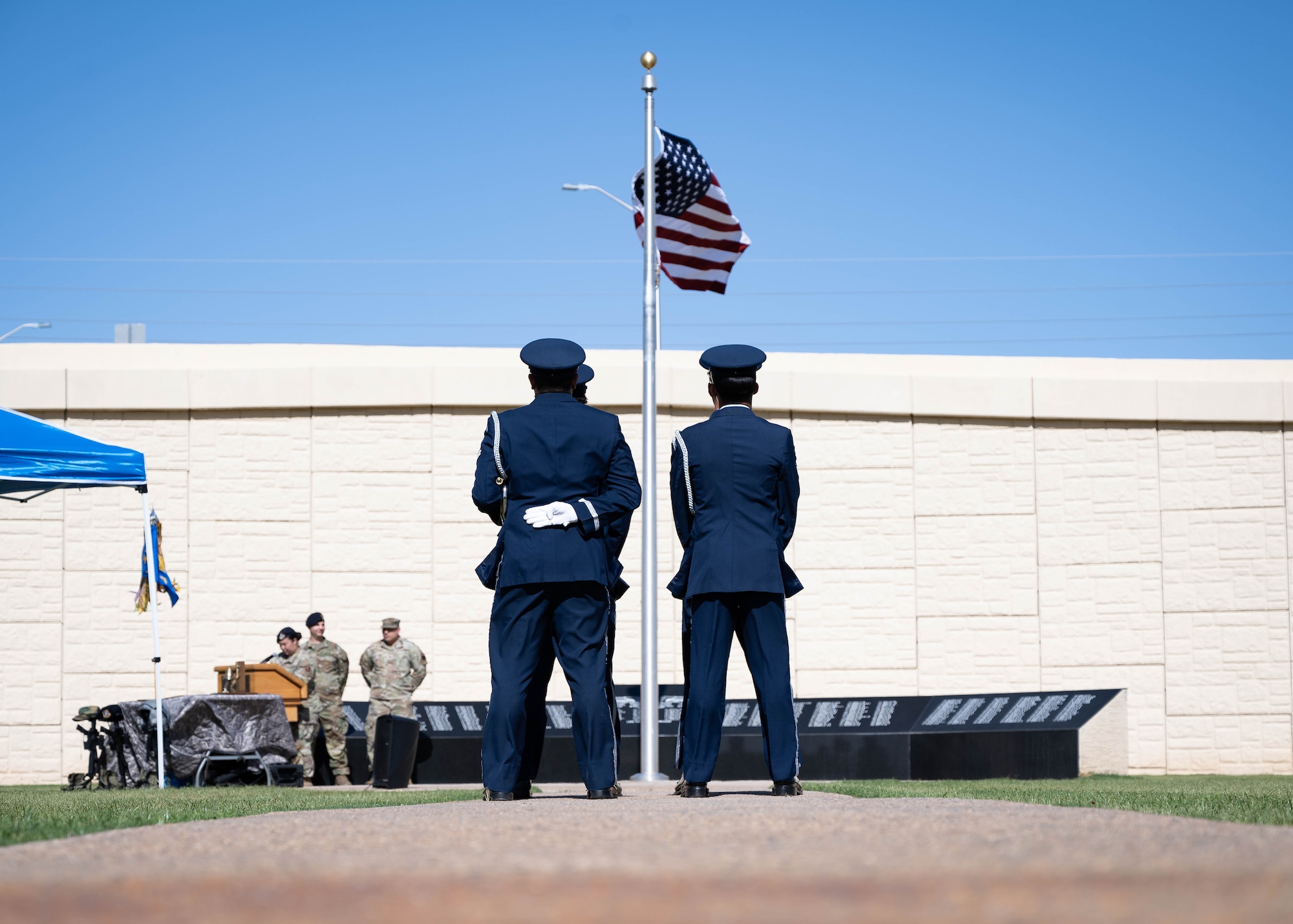 U.S. Air Force honor guardsmen assigned to the 56th Fighter Wing prepare to lower the U.S. flag during a POW/MIA retreat and memorial ceremony
