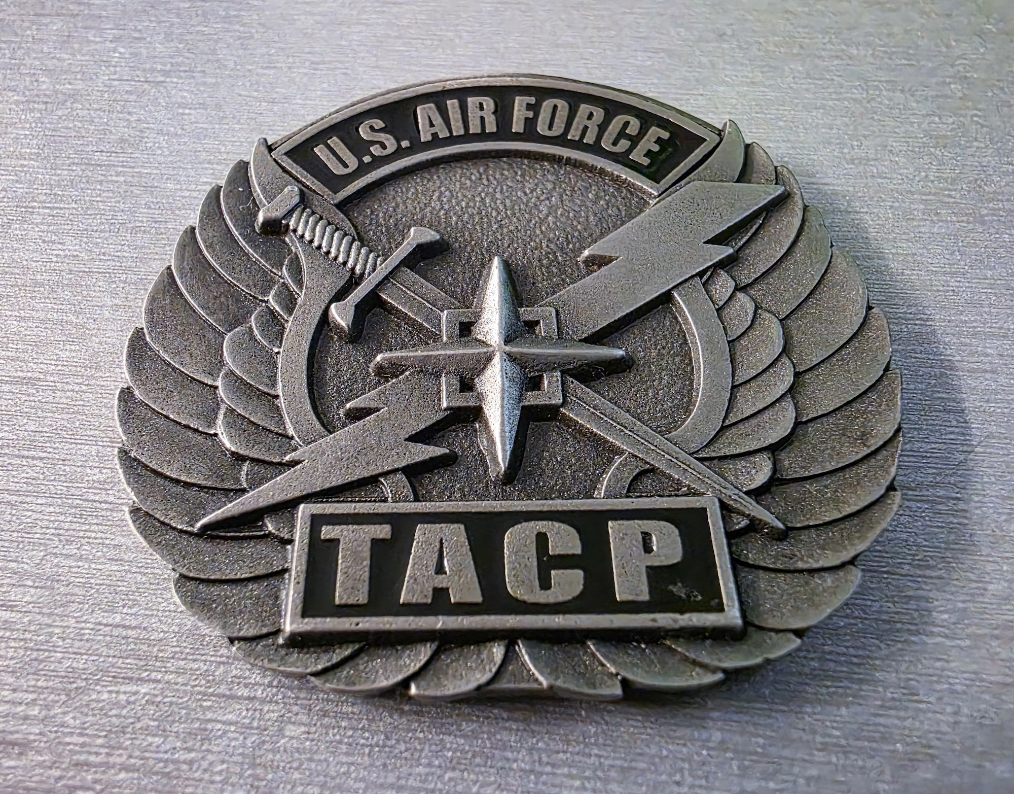 Photo of a U.S. Air Force TACP challenge coin from the 227th Air Support Operations Squadron is displayed at the 177th Fighter Wing of the New Jersey Air National Guard in Egg Harbor Township, N.J., May 15, 2025