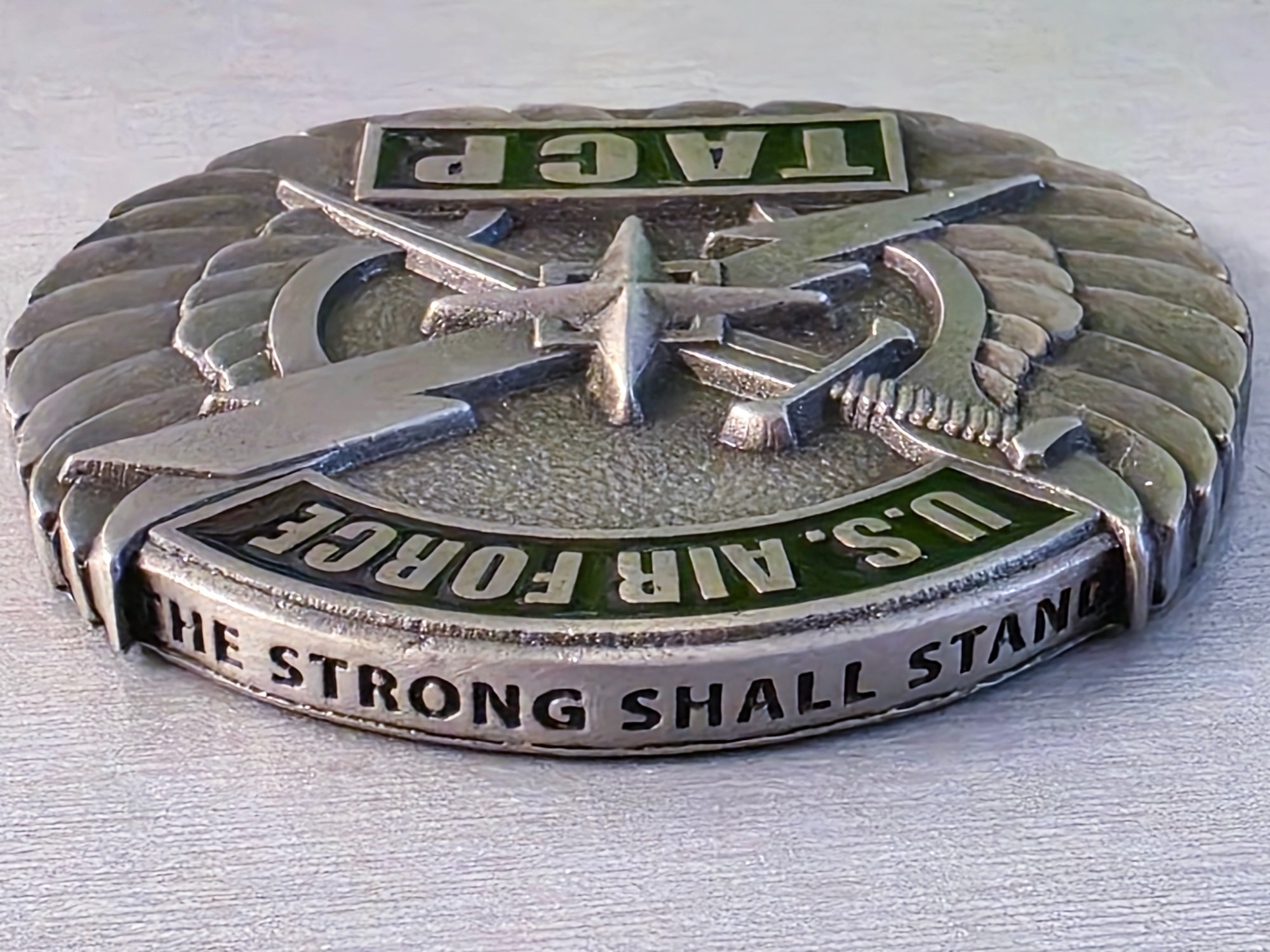Photo of a U.S. Air Force TACP challenge coin from the 227th Air Support Operations Squadron is displayed at the 177th Fighter Wing of the New Jersey Air National Guard in Egg Harbor Township, N.J., May 15, 2025