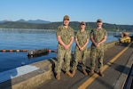 Machinist’s Mate (Submarines Auxiliary) 1st Class Jacob Baughman (left), Machinist’s Mate (Submarines Auxiliary) 1st Class Lydia Cleary (center) and Machinist’s Mate (Submarines Auxiliary) 2nd Class Alec Chambless (right), pose at Delta Pier, TRFB.