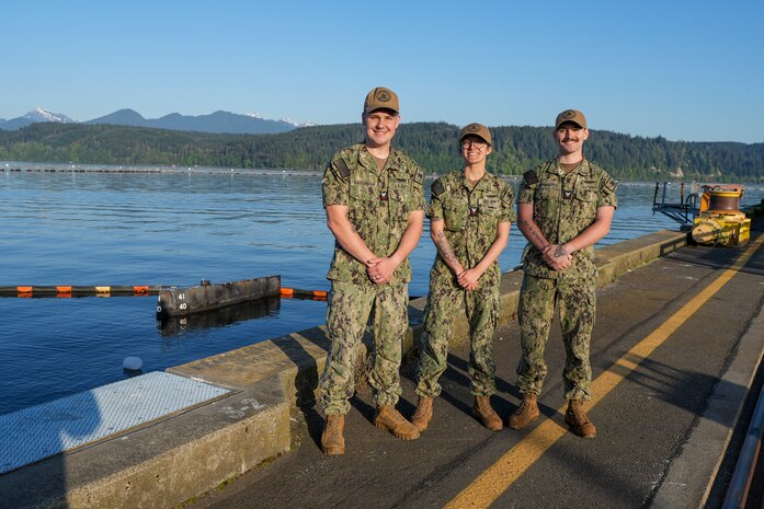 Machinist’s Mate (Submarines Auxiliary) 1st Class Jacob Baughman (left), Machinist’s Mate (Submarines Auxiliary) 1st Class Lydia Cleary (center) and Machinist’s Mate (Submarines Auxiliary) 2nd Class Alec Chambless (right), pose at Delta Pier, TRFB.