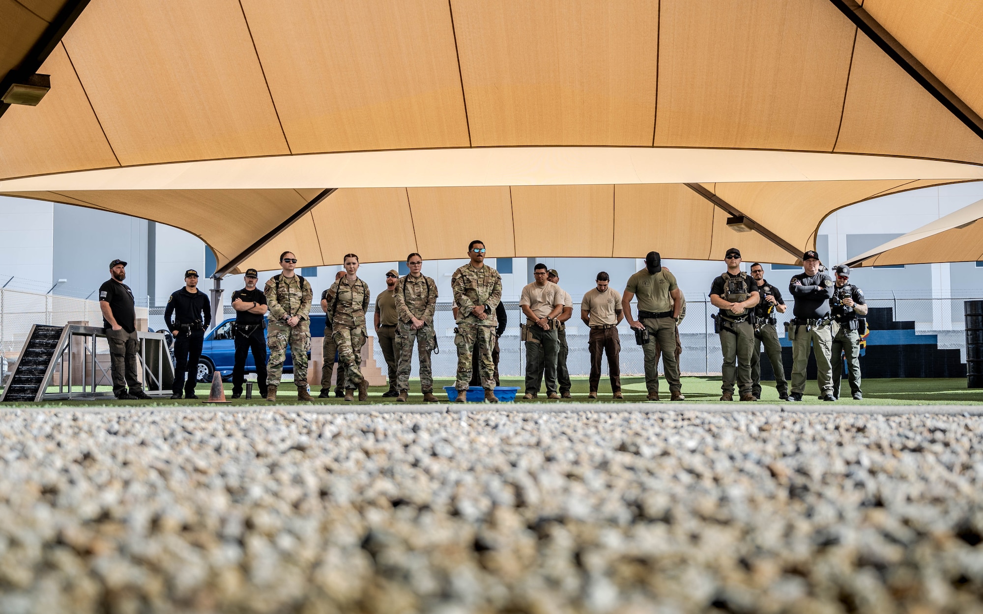 U.S. Air Force Airmen assigned to the 56th Fighter Wing and civilian law enforcement officers await the start of a K-9 competition
