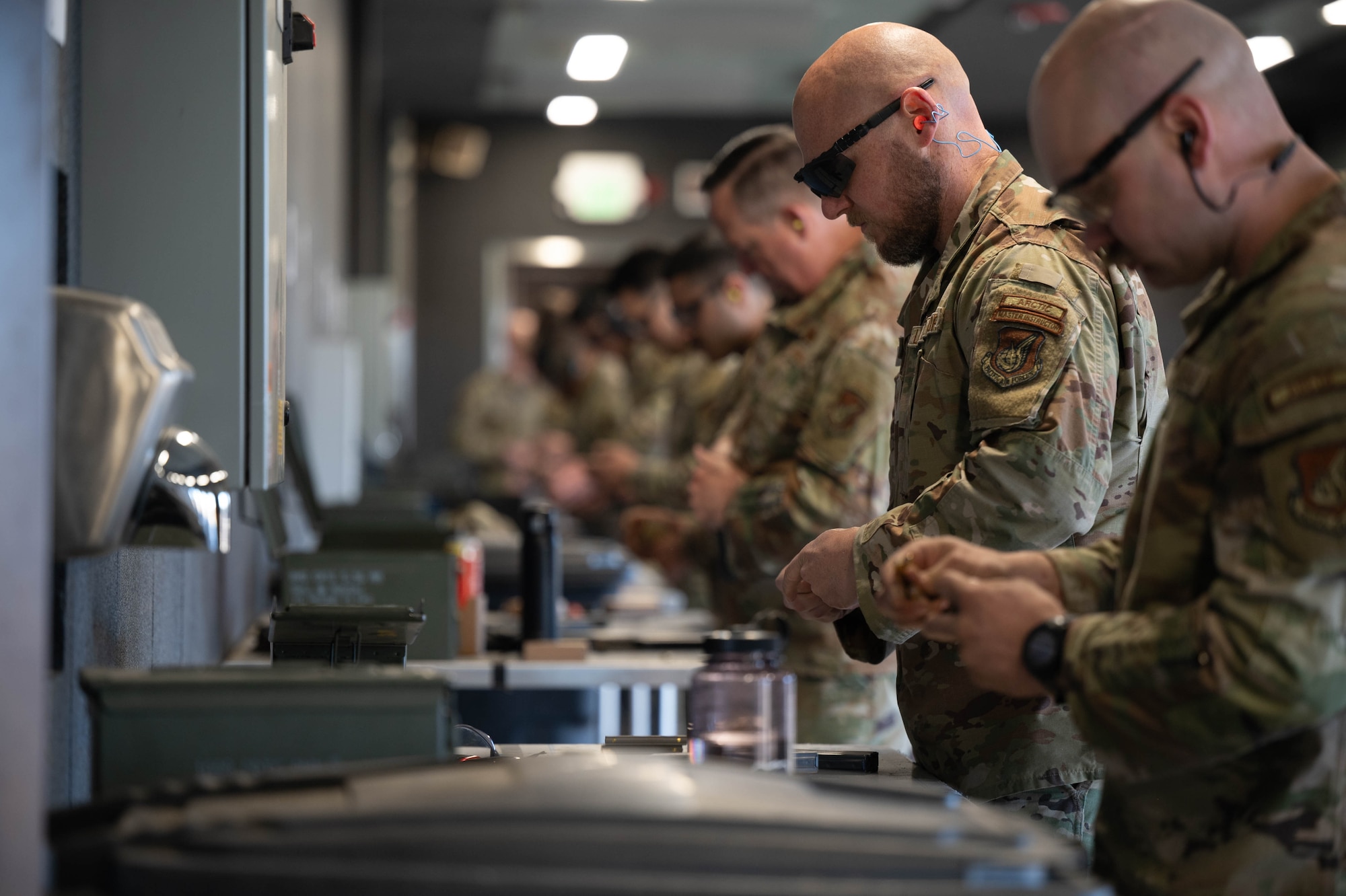 U.S. Air Force Airmen assigned to the 354th Fighter Wing load their magazines in preparation for a shooting competition at Eielson Air Force Base, Alaska, May 15, 2025.