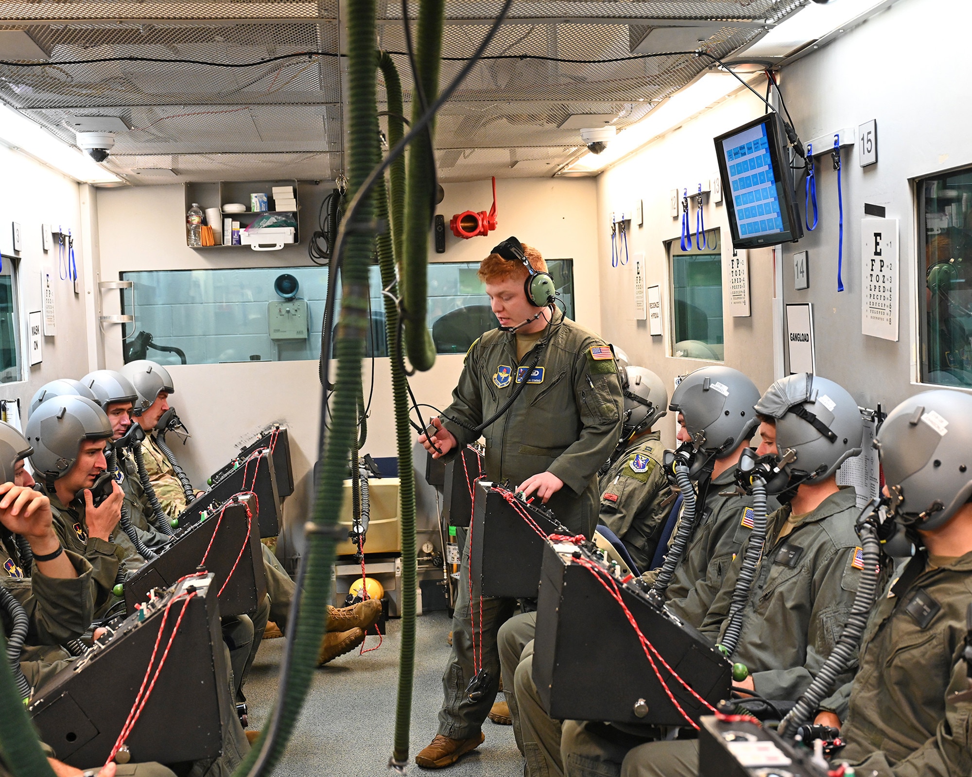 Airman 1st Class Bryson Esmond, 14th Operation Support Squadron Aerospace Physiology Technician, instructs Future Undergraduate Pilot Training (FUPT) student pilots in the Altitude Chamber.