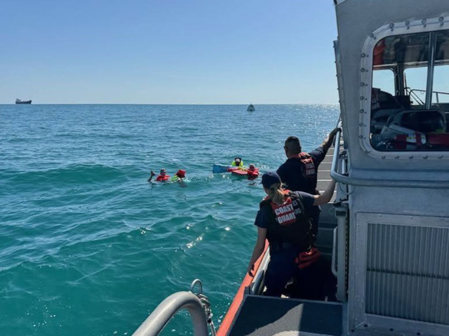 A Coast Guard Station St. Petersburg boat crew rescued three boaters, Friday, after their 29-foot boat capsized approximately six miles west of Bunces Pass.