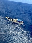 An MH-60 Knighthawk helicopter crew from U.S. Navy Helicopter Sea Combat Squadron 25 makes contact with mariners from the 47-foot motor vessel Lucky Harvest around 9:30 a.m., around 125 nautical miles west of Guam on May 16, 2025, before hoisting one mariner. A U.S. Coast Guard HC-130 Hercules airplane crew from Air Station Barbers Point in Hawai’i remained on scene with the vessel until the USCGC Myrtle Hazard (WPC 1139) arrived, rescued the second mariner, and took the vessel safely in tow, headed to Guam. (U.S. Naphoto)