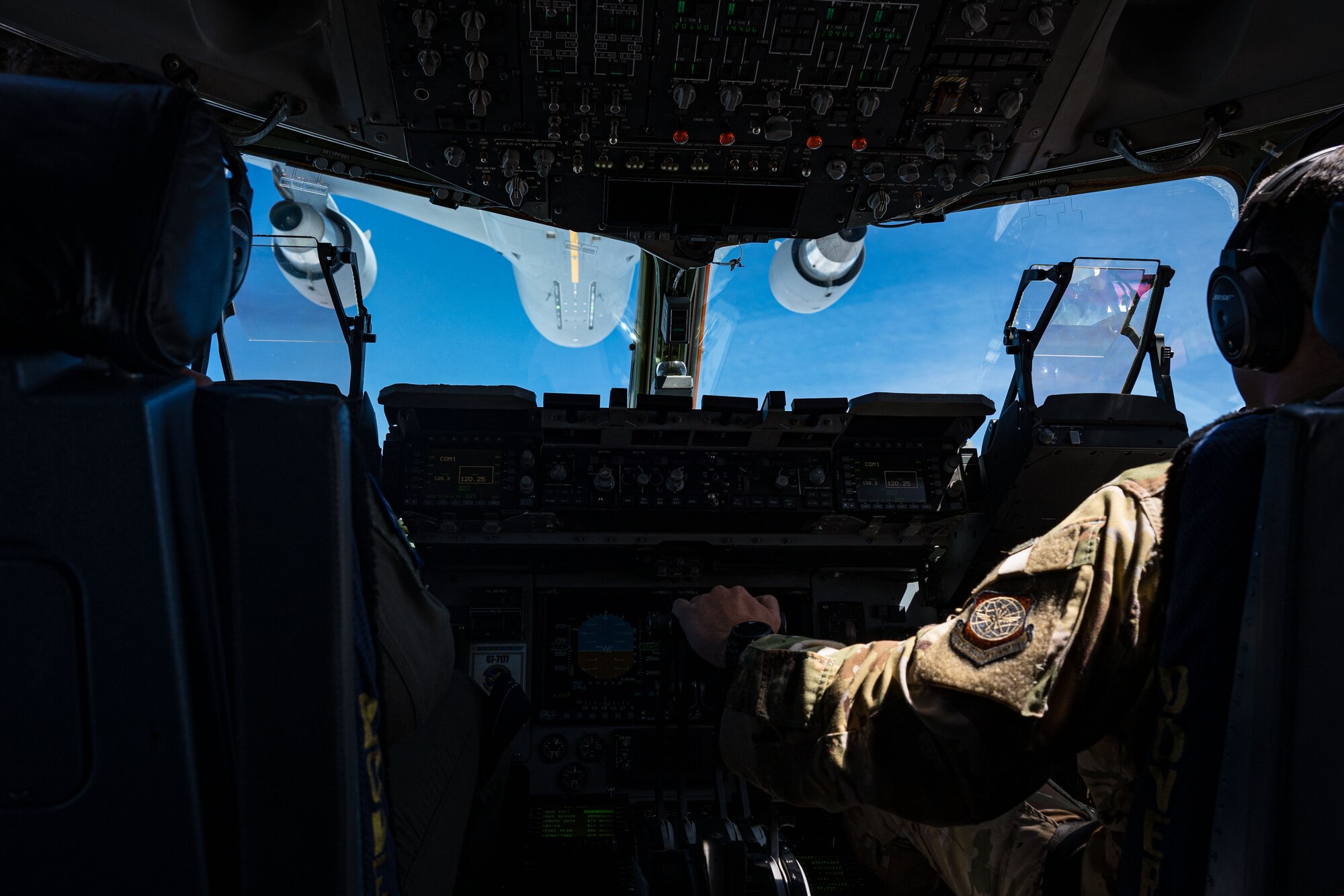 U.S. Air Force Capt. Thomas Heckman, right, 3rd Airlift Squadron pilot, aligns a C-17 Globemaster III to receive fuel during a Leadership Central Delaware orientation flight near the U.S. East Coast, May 15, 2025. The LCD program, operated by the Central Delaware Chamber of Commerce, visits Dover AFB annually to gain better understanding of base operations and to build community ties with the Air Force. (U.S. Air Force photo by Senior Airman Trenten Walters)
